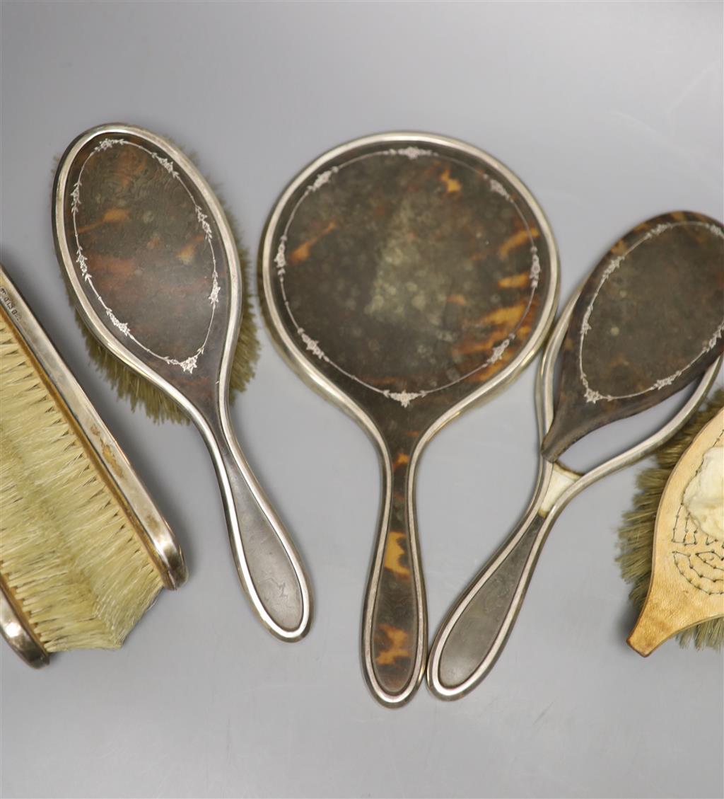 A George V silver and tortoiseshell five piece dressing table set, London 1925 (a.f.).